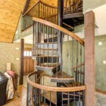 Rustic Home with Decorative, Wrought Iron Spiral Stair