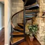forged iron spiral staircase with wood treads and handrail tucked in corner of living room